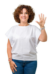 Sticker - Beautiful middle ager senior woman wearing white t-shirt over isolated background showing and pointing up with fingers number five while smiling confident and happy.