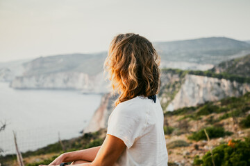 Wall Mural - woman tourist relaxing and watching rocks in the sea