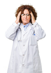 Canvas Print - Middle ager senior doctor woman over isolated background with hand on head for pain in head because stress. Suffering migraine.