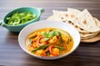 prawn curry with bell peppers served with naan bread