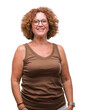 © Krakenimages.com - Middle age hispanic woman wearing glasses over isolated background with a happy and cool smile on face. Lucky person.