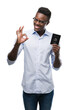 © Krakenimages.com - Young african american man holding passport of united states of america doing ok sign with fingers, excellent symbol