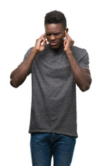 Poster - Young african american man wearing grey t-shirt covering ears with fingers with annoyed expression for the noise of loud music. Deaf concept.