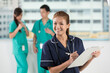 © Image Smith - Nurse standing in a hospital with her team