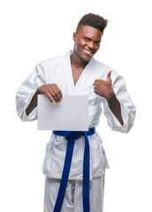 Poster - Young african american man over isolated background wearing kimono holding paper happy with big smile doing ok sign, thumb up with fingers, excellent sign