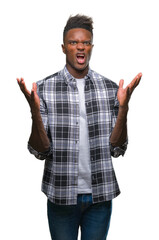 Canvas Print - Young african american man over isolated background crazy and mad shouting and yelling with aggressive expression and arms raised. Frustration concept.