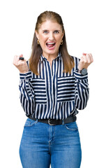 Sticker - Middle age mature business woman over isolated background celebrating surprised and amazed for success with arms raised and open eyes. Winner concept.