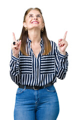 Poster - Middle age mature business woman over isolated background amazed and surprised looking up and pointing with fingers and raised arms.