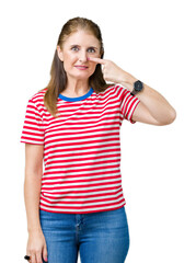 Poster - Middle age mature woman wearing casual t-shirt over isolated background Pointing with hand finger to face and nose, smiling cheerful