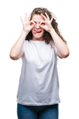 Poster - Beautiful brunette curly hair young girl wearing casual t-shirt over isolated background doing ok gesture like binoculars sticking tongue out, eyes looking through fingers. Crazy expression.