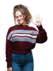 Canvas Print - Beautiful brunette curly hair young girl wearing glasses over isolated background showing and pointing up with fingers number five while smiling confident and happy.