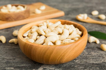 Wall Mural - cashew nuts in wooden bowl on table background. top view. Space for text Healthy food