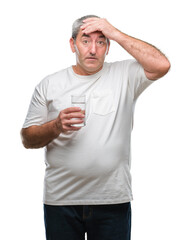 Sticker - Handsome senior man drinking glass of water over isolated background stressed with hand on head, shocked with shame and surprise face, angry and frustrated. Fear and upset for mistake.