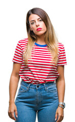 Poster - Young beautiful woman casual look over isolated background with serious expression on face. Simple and natural looking at the camera.