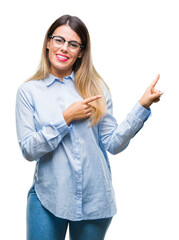 Sticker - Young beautiful business woman wearing glasses over isolated background smiling and looking at the camera pointing with two hands and fingers to the side.