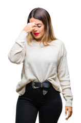 Wall Mural - Young beautiful woman casual white sweater over isolated background tired rubbing nose and eyes feeling fatigue and headache. Stress and frustration concept.