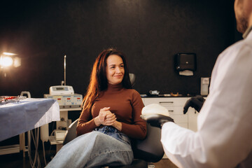 Canvas Print - Doctor showing silicone implants for breast augmentation to patient in clinic, closeup. Cosmetic surgery