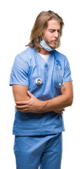 Poster - Young handsome doctor man with long hair over isolated background with hand on stomach because nausea, painful disease feeling unwell. Ache concept.