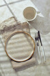 Empty plate, cutlery and a napkin on a light background. Table setting on table. Top view.