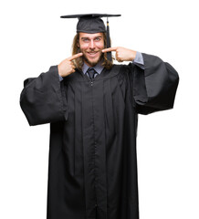 Sticker - Young handsome graduated man with long hair over isolated background smiling confident showing and pointing with fingers teeth and mouth. Health concept.