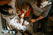 © Austockphoto - Overhead shot of family with young boy together on couch at home