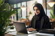 © bagoesanggito - a hijab woman working with her laptop