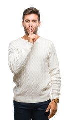 Poster - Young handsome man wearing winter sweater over isolated background asking to be quiet with finger on lips. Silence and secret concept.