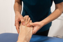 Physical therapist performing foot massage therapy