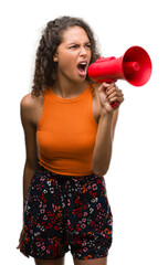 Sticker - Young hispanic woman holding megaphone annoyed and frustrated shouting with anger, crazy and yelling with raised hand, anger concept