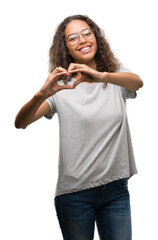 Canvas Print - Beautiful young hispanic woman wearing glasses smiling in love showing heart symbol and shape with hands. Romantic concept.