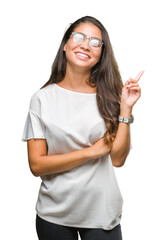 Canvas Print - Young beautiful arab woman wearing glasses over isolated background with a big smile on face, pointing with hand and finger to the side looking at the camera.