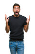 © Krakenimages.com - Adult hispanic man over isolated background celebrating crazy and amazed for success with arms raised and open eyes screaming excited. Winner concept