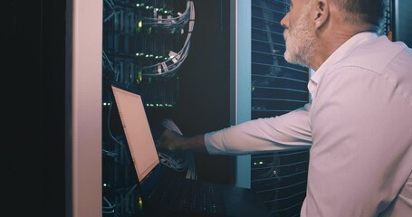 Leinwandbilder - Mature man in datacenter with laptop, cable for network maintenance or engineer in digital storage for data update. Tech support, system administration or technician online in server room on computer