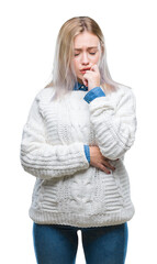 Sticker - Young blonde woman wearing winter sweater over isolated background looking stressed and nervous with hands on mouth biting nails. Anxiety problem.