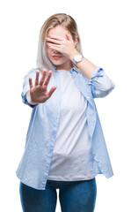 Sticker - Young blonde woman over isolated background covering eyes with hands and doing stop gesture with sad and fear expression. Embarrassed and negative concept.