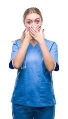 Sticker - Young blonde surgeon doctor woman over isolated background shocked covering mouth with hands for mistake. Secret concept.