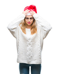 Sticker - Young beautiful blonde woman wearing christmas hat over isolated background suffering from headache desperate and stressed because pain and migraine. Hands on head.