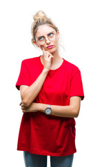 Sticker - Young beautiful blonde woman wearing red t-shirt and glasses over isolated background with hand on chin thinking about question, pensive expression. Smiling with thoughtful face. Doubt concept.