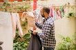 © Victor Mulero - Young man doing housework. Man hanging clothes. Outdoors.