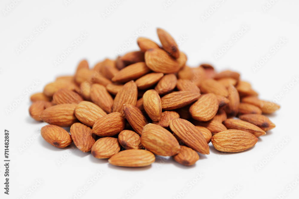 heap of almond nuts on white
