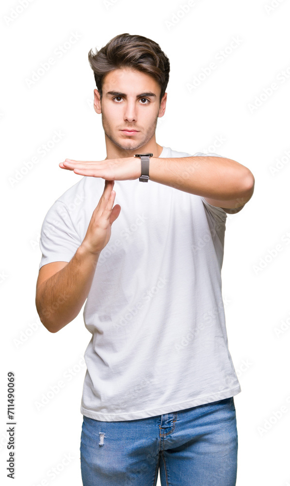 Young handsome man wearing white t-shirt over isolated background Doing time out gesture with hands, frustrated and serious face