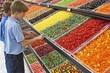 Kids picking candy from vibrant display, a colorful and exciting moment as children select their favorite sweets.