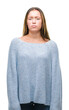 © Krakenimages.com - Young beautiful caucasian woman wearing winter sweater over isolated background skeptic and nervous, frowning upset because of problem. Negative person.