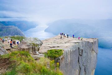 Wall Mural - Preikestolen and surrounding area, Norway. Lysefjorden below. Unrecognizable people.