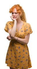 Sticker - Young redhead woman looking stressed and nervous with hands on mouth biting nails. Anxiety problem.