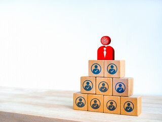 Sticker - Business leadership, the leader goal, organization development concepts. Big red businessman with target icon on top of colleague or company staff on wooden blocks pyramid shape on white background.