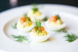 Fototapeta Tulipany - brightly lit deviled eggs with fresh dill garnish
