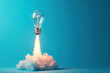 © Deivison - Light bulb taking off like rocket on blue background, startup and business concept.