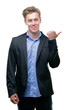 © Krakenimages.com - Young handsome blond business man pointing with hand and finger up with happy face smiling