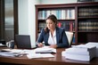 © studioworkstock - paralegal reviewing legal documents at desk with laptop